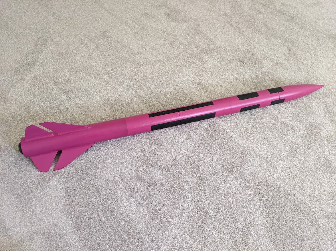 A pink rocket with black accents